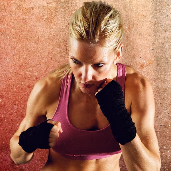 Mixed Martial Arts Lessons for Adults in Norwood NJ - Lady Kickboxing Focused Background