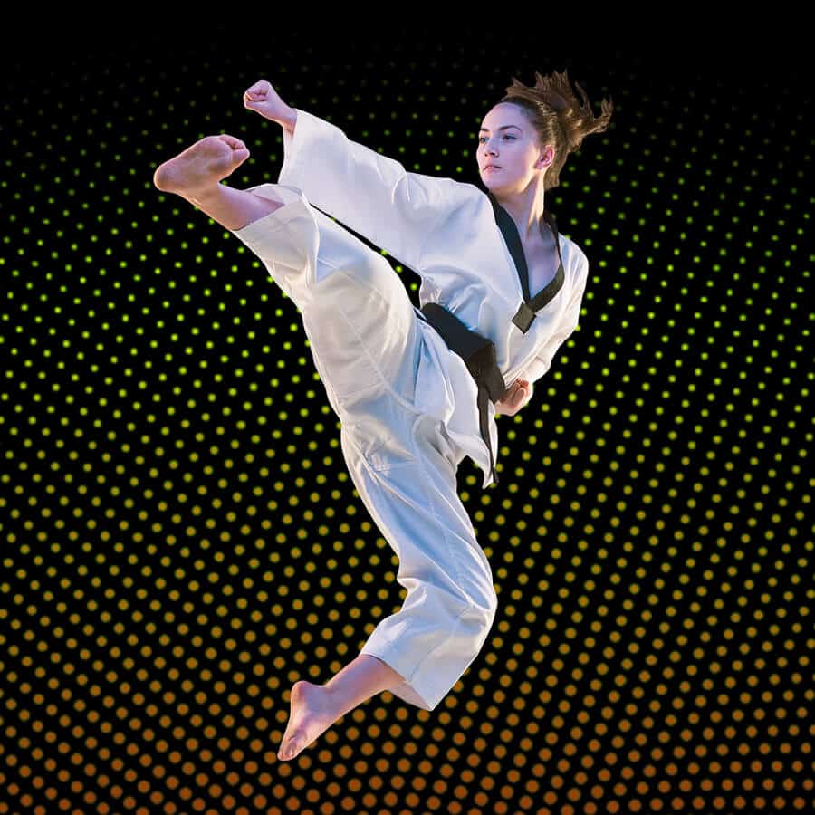 Martial Arts Lessons for Adults in Norwood NJ - Girl Black Belt Jumping High Kick