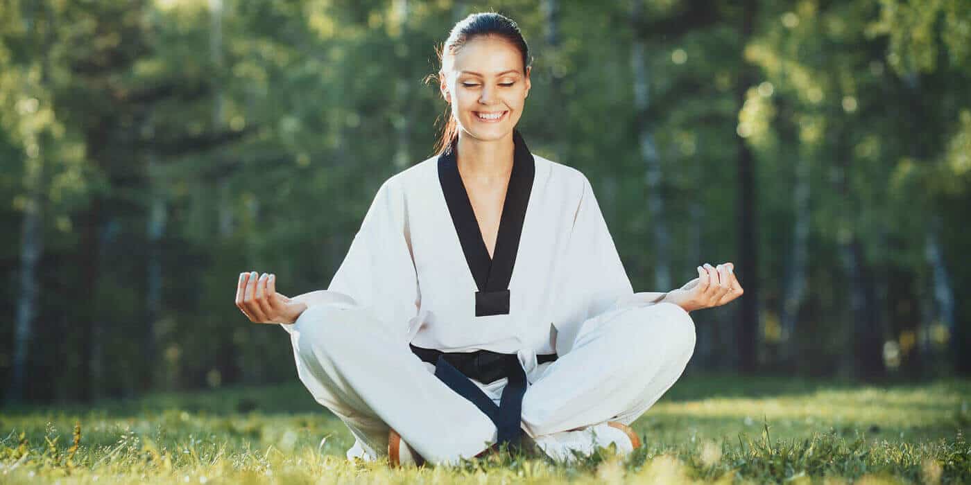 Martial Arts Lessons for Adults in Norwood NJ - Happy Woman Meditated Sitting Background